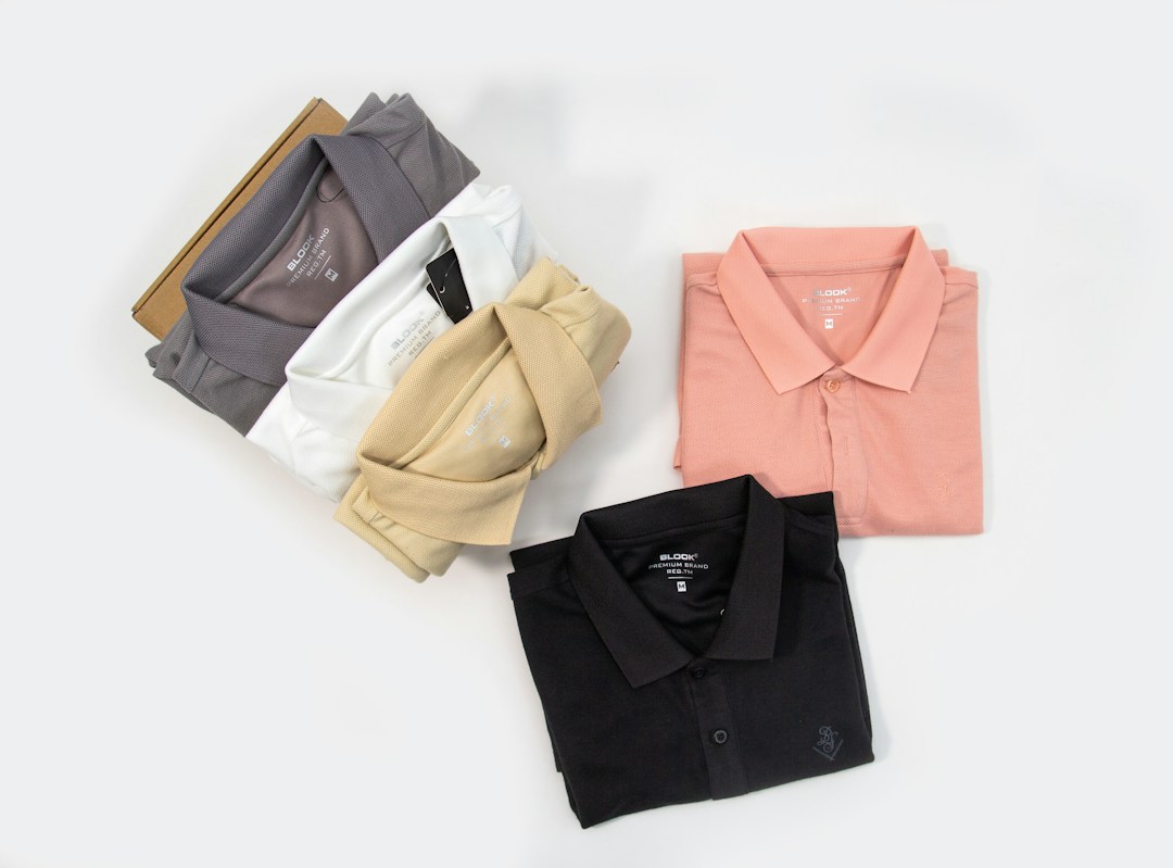 Four polo shirts in different colors laid out for styling comparison